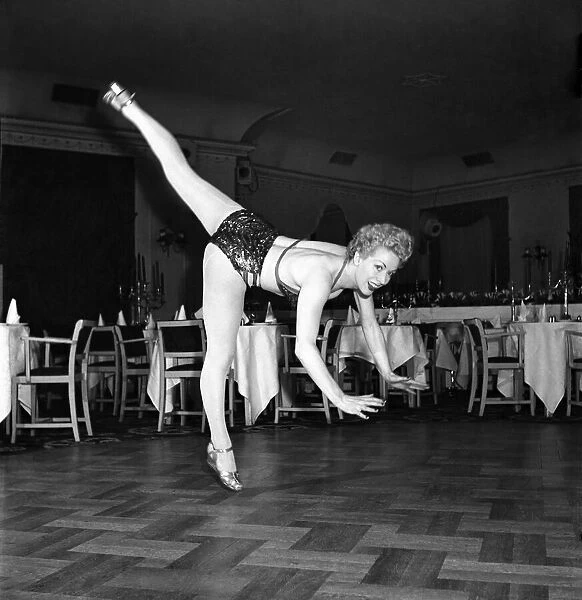 An Ice Skating Clown performing above parquet flooring. January 1953 D597-007