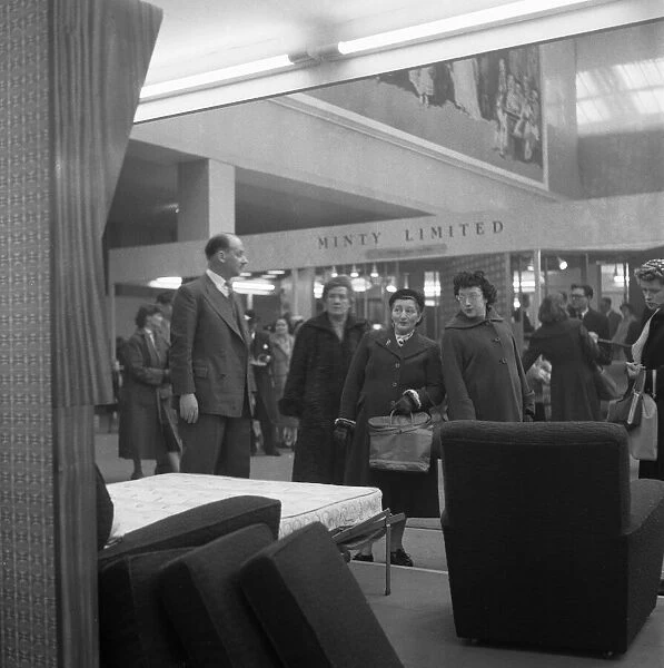 Ideal Home Exhibition Olympia. 3rd March 1955 Housewives admire the latest sofa bed