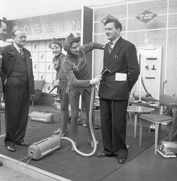 Ideal Home Exhibition Olympia. 3rd March 1955 A journalist is hoovered by a sales