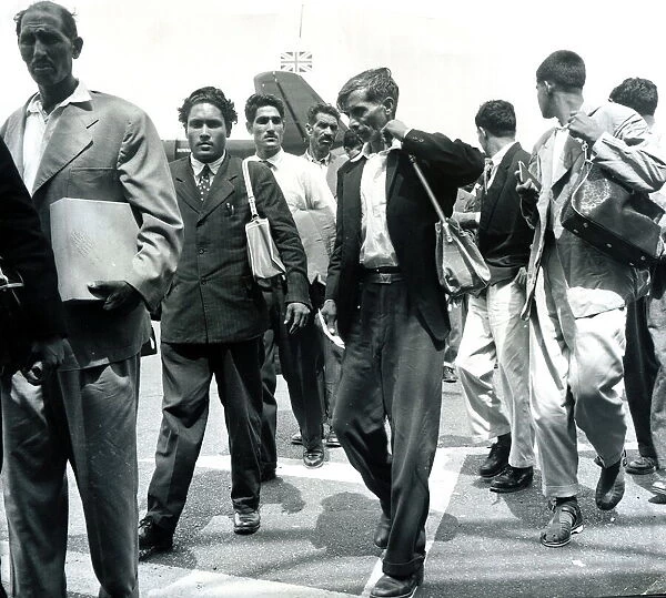 Immigration to Britain Airport shot, carrying bags Men July 1962