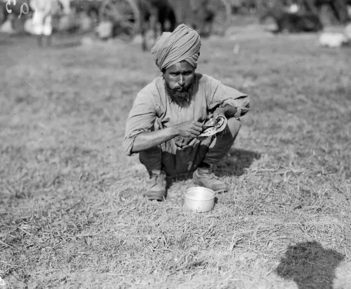 Framed Print : Indian soldier eating a chapatti during his stay at the Indian army rest camp on the race