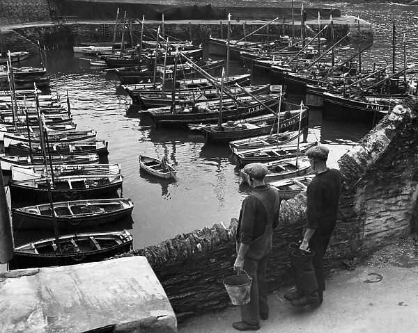 Industry: Fishing. The days work ended, fishing boats moved secure in the tiny harbour at