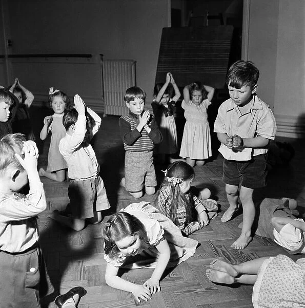 Infant schoolchildren playing during a dance and movement class. Feburary 1953 D715-002