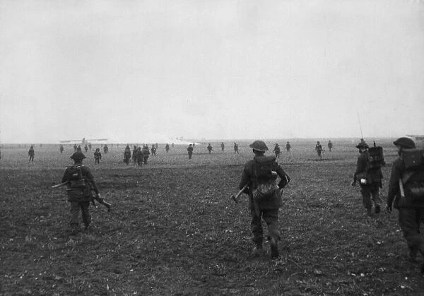 Infantry of the Glasgow Highlanders and the Coldstream Guards double across the flat