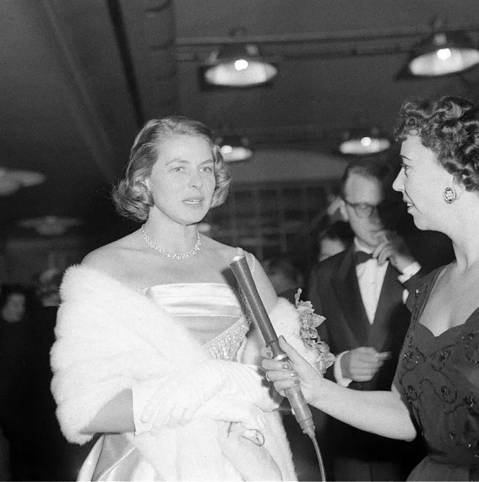 Framed Print : Ingrid Bergman wearing a satin dress and fur stole at the premiere of a film November