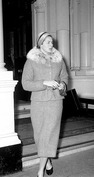 Ingrid Bergman window shopping in Bond Street London wearing fur trimmed tweed suit