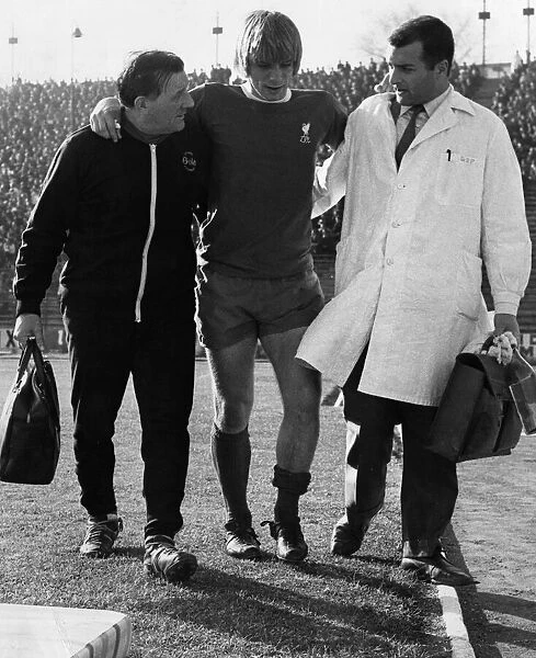 Injured Liverpool footballer Alun Evans helped off the pitch by Bob Paisley (left
