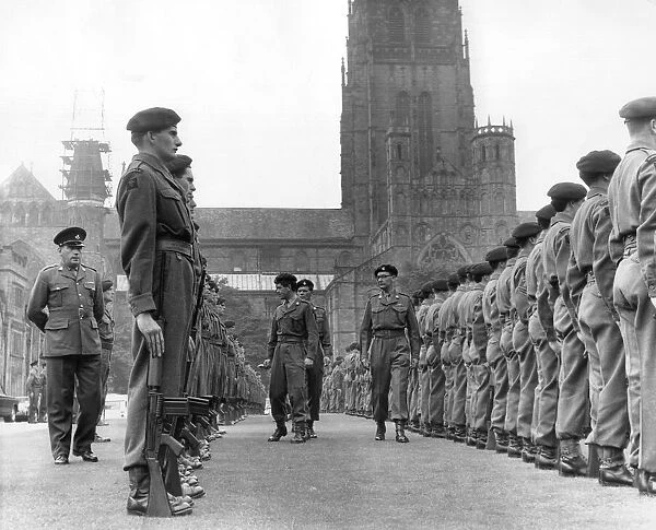 Inspecting officers move through the ranks of soldiers from the Durham Light Infantry T. A