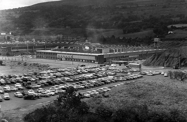 Instead of the long dole queues, a shiny row of cars. This scene at the Hoover factory
