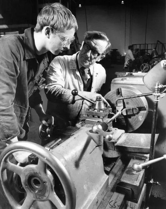 Framed Print : Instructor Bobby Hunter demonstrates lathe turning to apprentice Ian Summerville