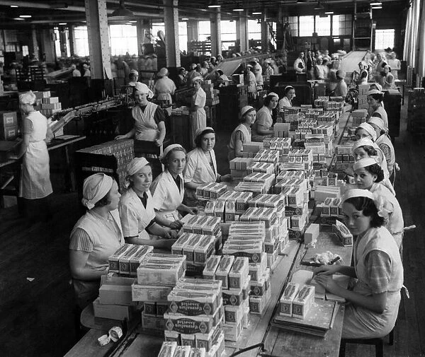 The interior of Huntley & Palmers factory, women packing cartons of Coronation Assorted