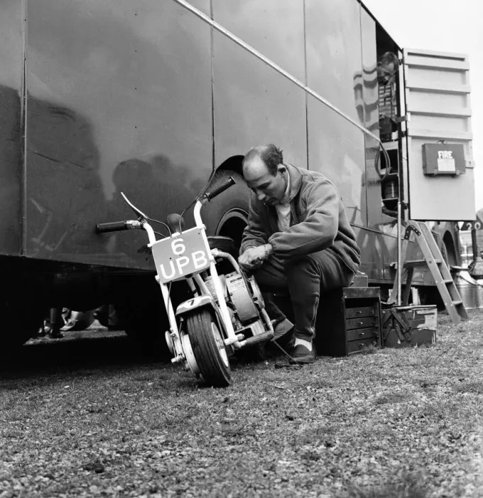 Framed Print : International 200 at Aintree motor circuit. Stirling Moss tinkers about with his scooter