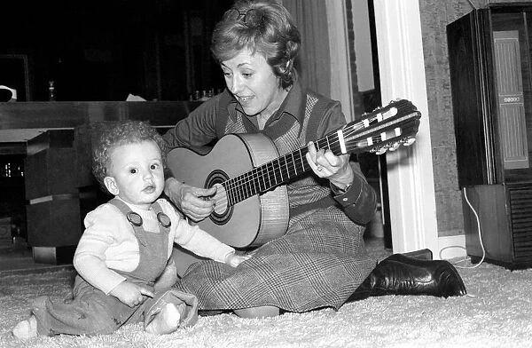 International singer star: Caterina Valente serenades her son. February 1975 75-00827-005