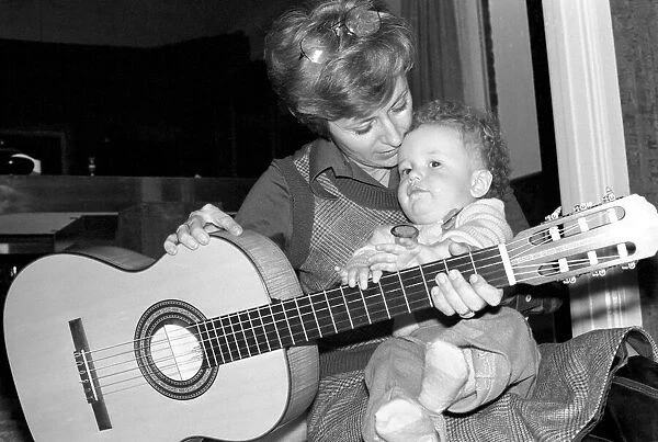 International singer star: Caterina Valente serenades her son. February 1975 75-00827-003