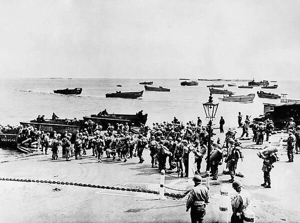 Invasion Embarkation. Battled-dressed U.s soldiers file down embarkment of an