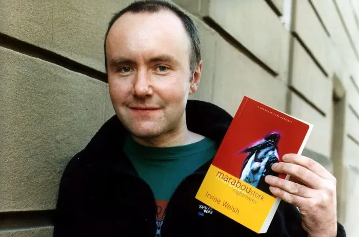 Framed Print : Irvine Welsh author wearing blue fleece jacket green T shirt holding copy of his book Framed Print : Irvine Welsh author wearing blue fleece jacket green T shirt holding copy of his book