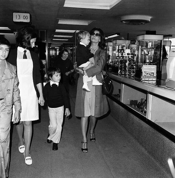 Italian actress Sophia Loren and her two children leaving Heathrow Airport for Rome