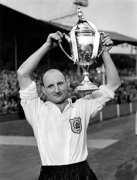 J Nimmins, the Bishop Auckland captain holds The FA Amateur Cup above his head after