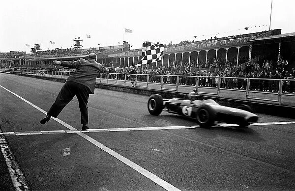 Jack Brabham gets the Chequered flag at the end of the Aintree International 200