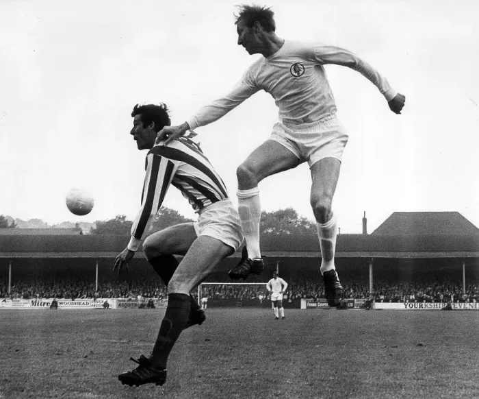Framed Print : Jack Charlton of Leeds United jumps up to beat John Ritchie during their league match