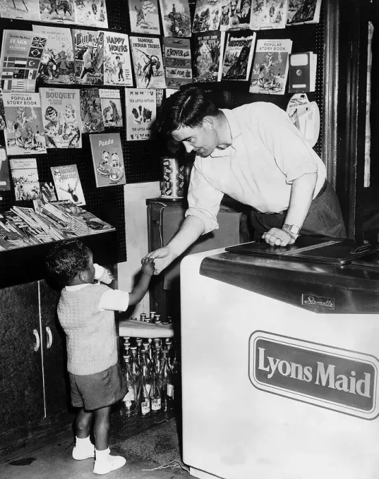 Framed Print : Jackie Blanchflower of Manchester United serves an ice cream to a young boy in his newly