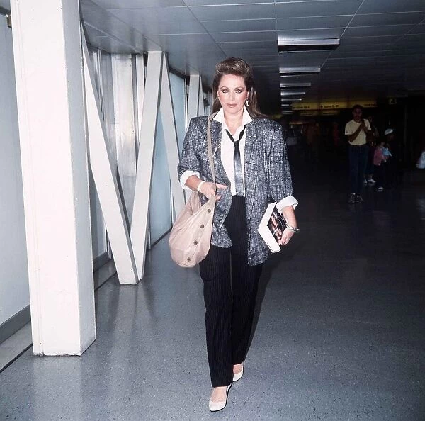 Jackie Collins arriving at Heathrow with her new book September 1985