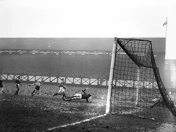 Jackie Milburn of Newcastle United scores a goal against Portsmouth. FA Cup Quarter-final