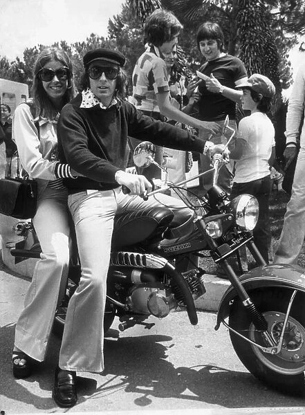 JACKIE STEWART AND WIFE HELEN ON A MOTOR BIKE AFTER HIS MONACO GRAND PRIX VICTORY JUNE