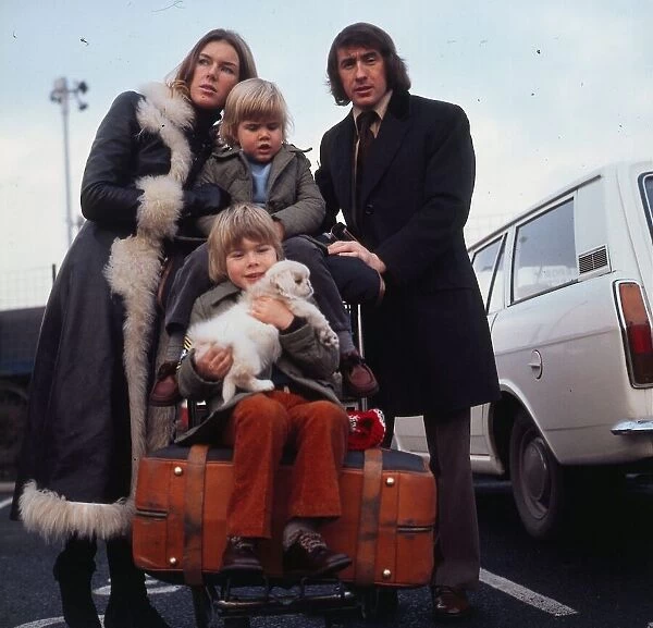 Jackie Stewart with wife Helen Stewart and their two young sons who are sitting on a