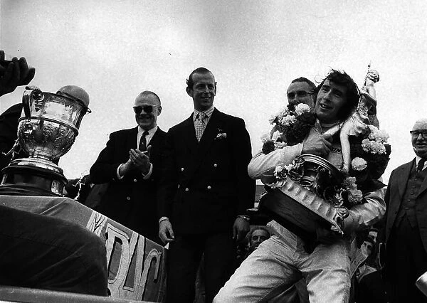 Jackie Stewart after winning British Grand Prix holding trophy