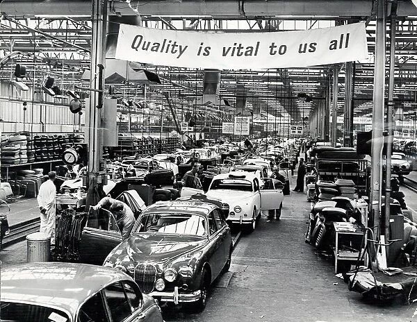 Jaguar Cars, Browns Lane, Coventry, production line. The banner above the track reads