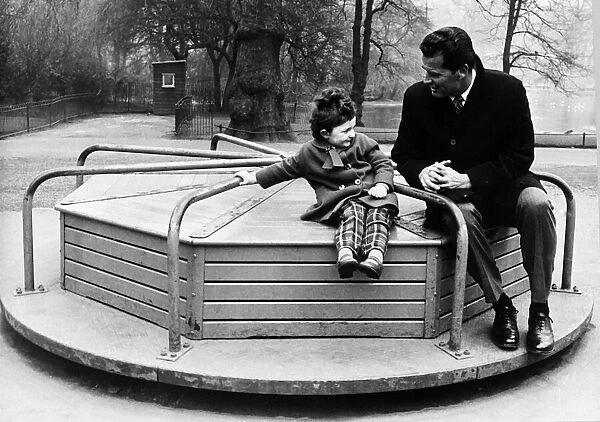 James Garner American actor on roundabout with child 1964
