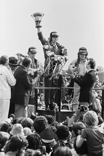 James Hunt on the podium celebrates winning The 1977 British Grand Prix Formula One