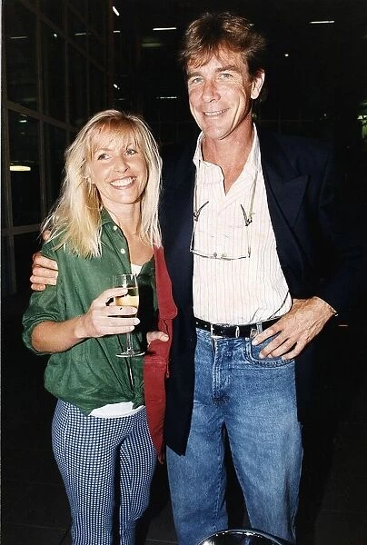 James Hunt racing driver with arm around Helen Dyson