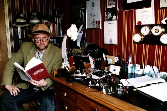 Framed Print : James Whale TV and Radio Presenter Sitting at desk holding book Framed Print : James Whale TV and Radio Presenter Sitting at desk holding book