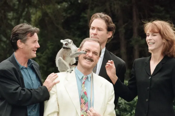 Framed Print : Jamie Lee Curtis, John Cleese (centre in the white jacket and jeans)