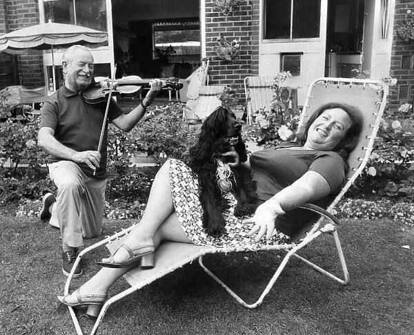 Janet relaxes at home with her husband Charles, a professional violinist