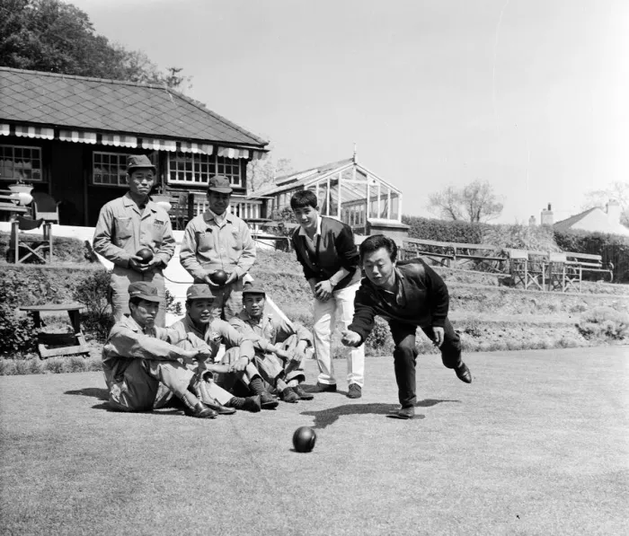 Framed Print : Japanese rider Shimazaki playing bowls with his team of mechanics watching Framed Print : Japanese rider Shimazaki playing bowls with his team of mechanics watching