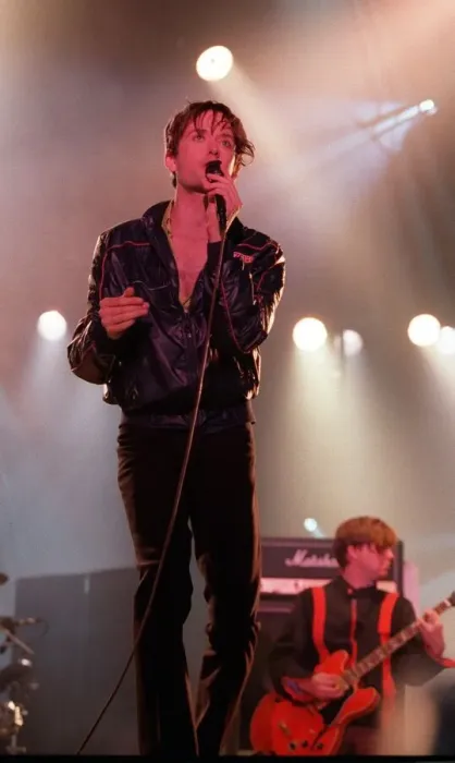 Framed Print : Jarvis Cocker of pop group Pulp singing into microphone on stage at T in the Park