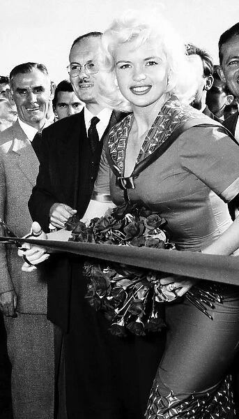 Jayne Mansfield cuts red tape at ceremony in London September 1959