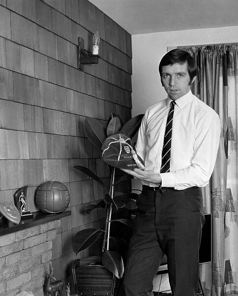 Jeff Astle pictured at home, with some of his trophies and one of his England caps