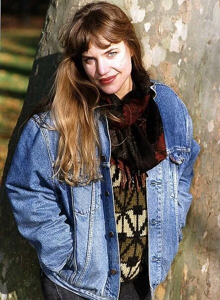 Jennifer Calvert Actress Standing against a tree. Wearing a denim jacket