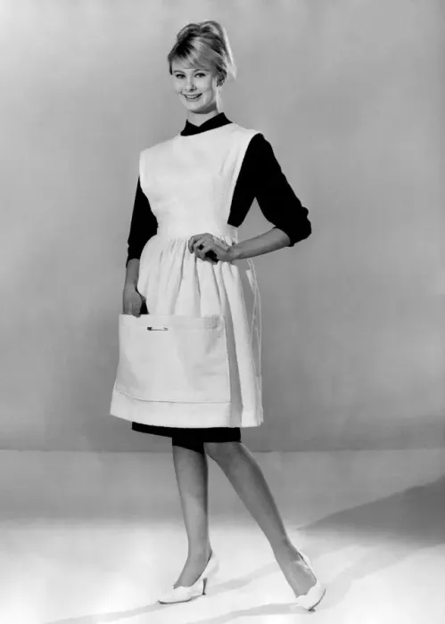 Framed Print : Jennifer Wilson wearing an apron over her black dress. March 1960 P009010 Framed Print : Jennifer Wilson wearing an apron over her black dress. March 1960 P009010