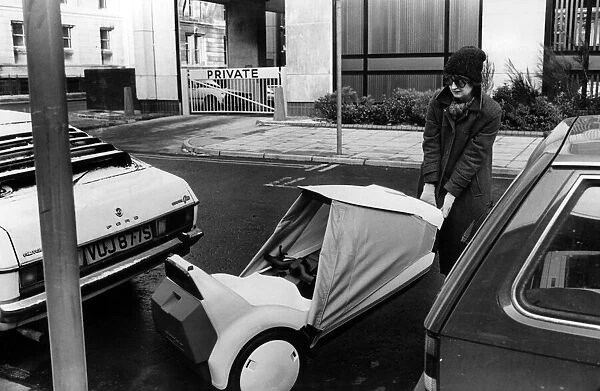 Jenny finds a convenient parking space for her Sinclair C5, between two cars