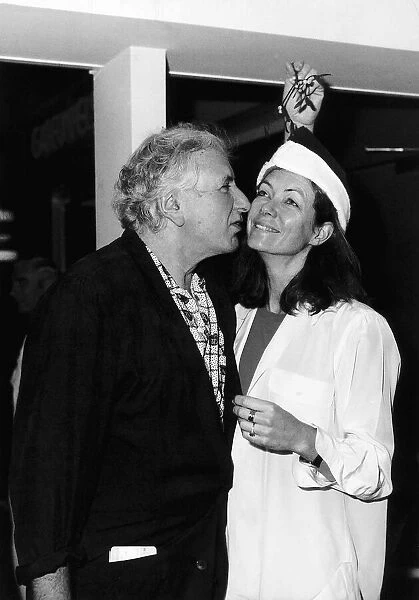 Jenny Seagrove Actress with Film Director Michael Winner kissing under a mistletoe