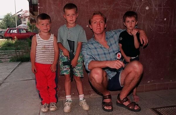 Jerome Flynn actor with children in Bosnia travelling with Red Cross