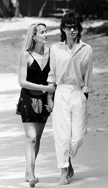 Jerry Hall arm with her boyfriend Rolling Stones; Mick Jagger in Barbados March 1987