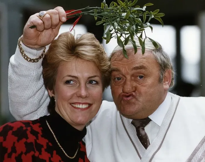 Framed Print : Jill Dando TV Presenter with Les Dawson who is holding mistletoe over their heads Framed Print : Jill Dando TV Presenter with Les Dawson who is holding mistletoe over their heads