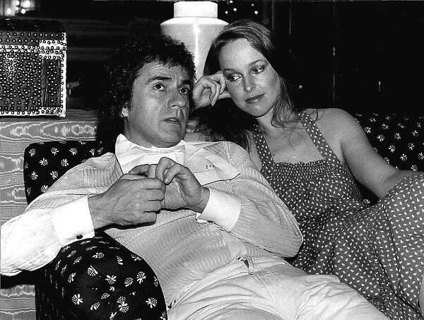 Jill Eikenberry sitting on a sofa with Dudley Moore actor and musician dbase
