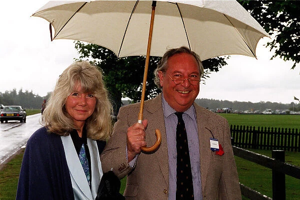 Jilly Cooper writer and husband Leo Cooper arrive in the rain for the Alfred Dunhill